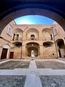 a large brick building with balconies on it at Dimora Palazzo De Luca - Intra Alborgodiffuso - Loft di Charme del 700 con Vasca doppia e Camino in Serracapriola