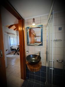 a bathroom with a sink and a glass shower at Blu Casa Del Mare in Monemvasia +18 photos
