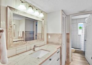 a bathroom with a sink and a large mirror at Bay view Siesta Key condo - two pools - tennis and pickleball - beach access - GBB 1343 in Siesta Key +27 photos