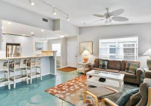 a living room with a couch and a kitchen at Bay view Siesta Key condo - two pools - tennis and pickleball - beach access - GBB 1343 in Siesta Key