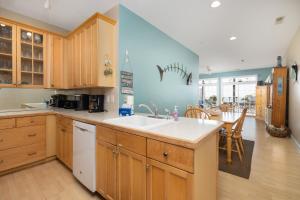 a kitchen with a sink and a dining room at Beachwalk Villas 22 in Folly Beach