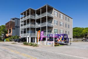 a tall apartment building with a purple on a street at Beachwalk Villas 22 in Folly Beach