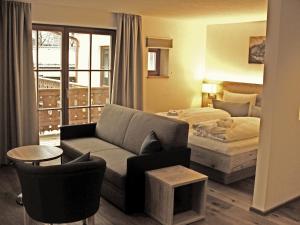 a living room filled with furniture and a window at Mammhofer Suite & Breakfast in Oberammergau