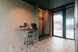 a kitchen with a counter and a bar with a stool at Wijndomein Leine in Opwijk +8 photos
