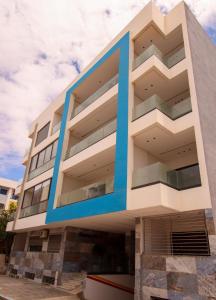 a building with blue accents on the side of it at Marina plage in Kenitra