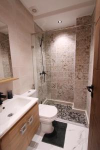 a bathroom with a shower and a toilet and a sink at Marina plage in Kenitra