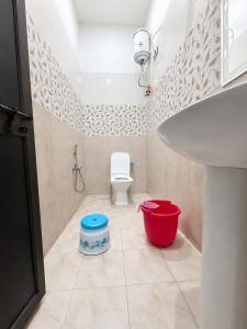 a bathroom with a white sink and a toilet at Bholenath Guest House 500 Mitter From Shree Ram Manidr in Faizābād