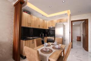 a kitchen with a wooden table and a dining room at Marina plage in Kenitra