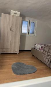 a bedroom with a bed and a cabinet and a rug at AG Scalo d amore house in Naples