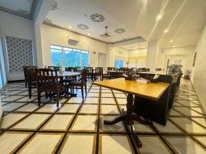 a restaurant with tables and chairs in a room at Sky villa with pool in Nāi +51 photos