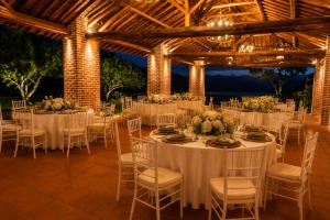 a wedding reception with white tables and chairs at Hotel Finca Buenos Aires Barichara in Barichara +77 photos