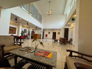 a lobby with a table and chairs and a living room at Sky villa with pool in Nāi