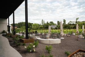 a patio with tables and chairs and umbrellas at Wijndomein Leine in Opwijk