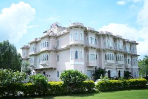 a large white building with trees in front of it at Sky villa with pool in Nāi