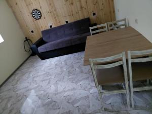 a living room with a table and a couch at Gamma house in Dprabak +8 photos