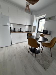 a kitchen with a table and chairs in a room at Apartment in Ploiești 4 in Ploieşti