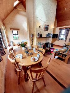 a large room with a wooden table and chairs at Fanore Holiday Cottages in Ballyvaughan