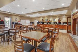 a restaurant with tables and chairs and a counter at Best Western Plus Meridian in Lloydminster
