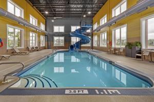 a indoor swimming pool with a slide in a building at Best Western Plus Meridian in Lloydminster