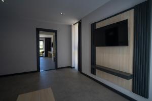 a living room with a flat screen tv on a wall at Demederon Hotel in Hamsikoy