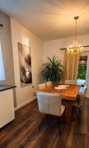 a dining room with a wooden table and a chandelier at Villa Olivia in Banjole