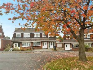 a large house with a tree in front of it at Nordic Spa House in Brandon