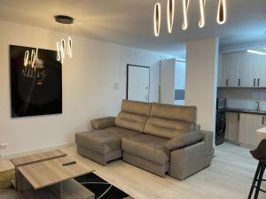 a living room with a couch and a table at Apartment in Ploiești 5 in Ploieşti +8 photos