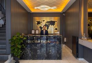a reception desk in a hotel lobby with a sign that reads reception at Park Marina Hotel in Kemer