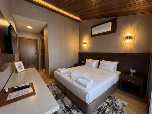 a hotel room with a large bed and a desk at Park Marina Hotel in Kemer