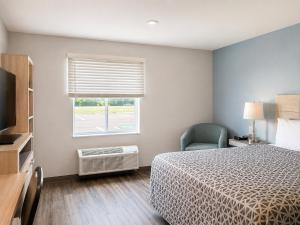 a hotel room with a bed and a window at WoodSpring Suites Jackson Hub City in Jackson +33 photos