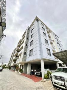 a large white building with two people standing in front of it at CBC Towers in Lagos