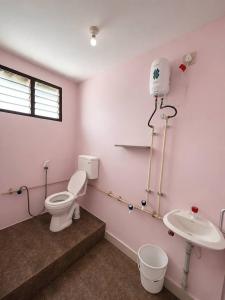 a bathroom with a toilet and a sink at Hotel Bypass in Madurai