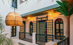 a house with a balcony with a door at The Little Hara in Marrakesh
