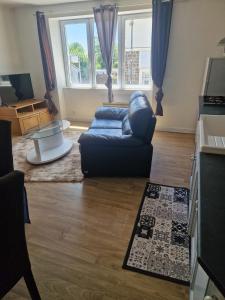a living room with a couch and a table at Appartement 2 Ch la Romagne in La Romagne