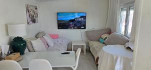 a living room with a couch and a table at Casita Costa in Miengo