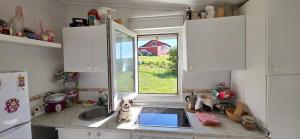 a small kitchen with a sink and a window at Casita Costa in Miengo