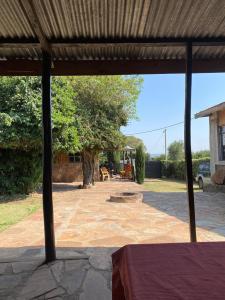 a view of a patio with a table and a tree at Empiris Lodge in Sekenani