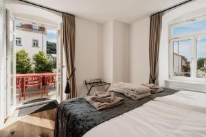 a bedroom with a bed and a large window at Schloss am Bodensee I Private Sauna & Whirlpool in Stockach