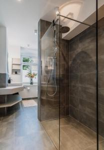 a shower with a glass door in a bathroom at Schloss am Bodensee I Private Sauna & Whirlpool in Stockach +23 photos