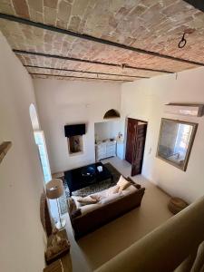 a view of a living room with a couch at Dimora Palazzo De Luca - Intra Alborgodiffuso - Loft di Charme del 700 con Vasca doppia e Camino in Serracapriola