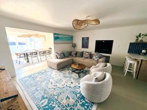 a living room with a couch and a table at House Charisma in Britannia Bay