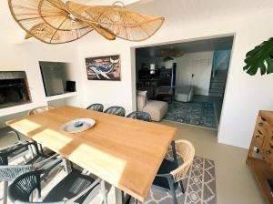 a dining room with a wooden table and chairs at House Charisma in Britannia Bay
