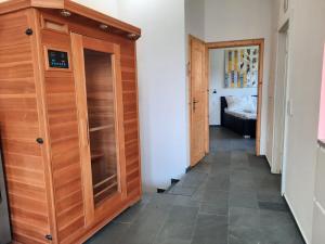 a hallway with a wooden cabinet in a room at Wohnung in einer kleinen Burg in Neunkirchen