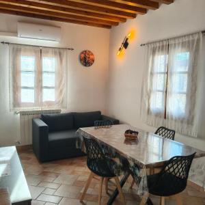 a living room with a table and a couch at Tuscan Sunsets Tramonti Toscani in Fauglia