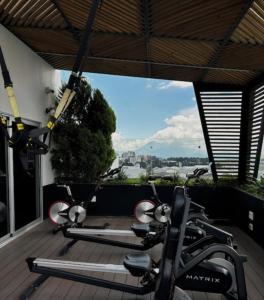 a group of exercise bikes on a deck with a view at Narama 1 - Apartamento cerca del aeropuerto - Zona 13 de la Ciudad de Guatemala in Estación Pamplona +4 photos