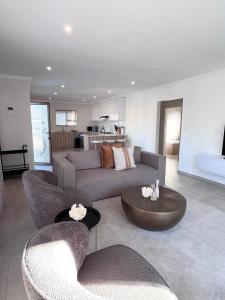 a living room with a couch and chairs and a table at Zahari Villas in Parys +18 photos