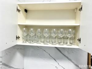 a row of wine glasses on a shelf at Casaxxvaprile in Turin