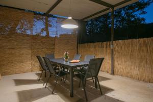 a table and chairs on a patio with a ceiling at Villa Ginger Modern Villa with Private Pool in Omiš