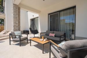 a living room with a couch and chairs and a table at Villa Ginger Modern Villa with Private Pool in Omiš +46 photos