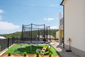 a trampoline on the balcony of a house at Villa Ginger Modern Villa with Private Pool in Omiš